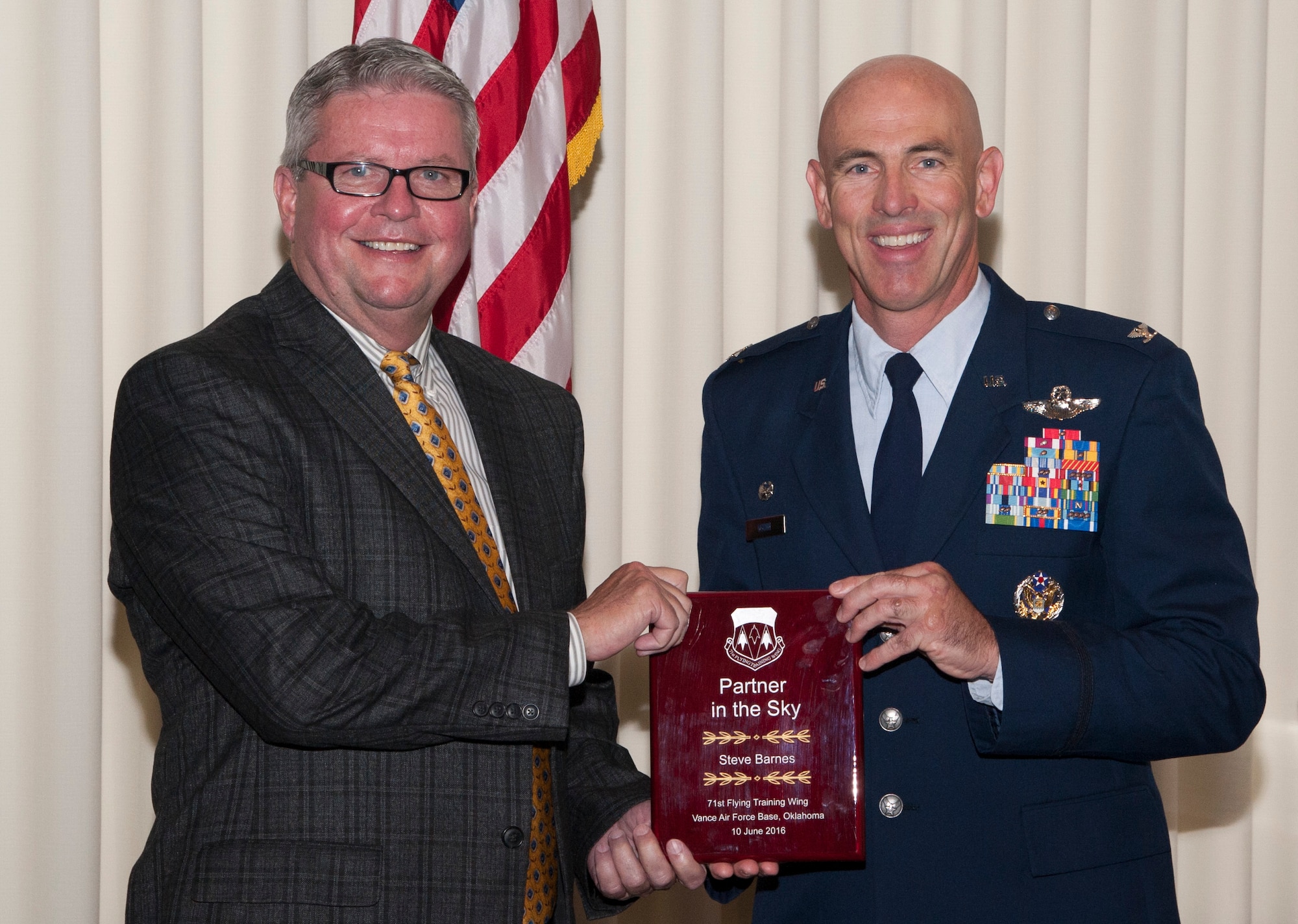 Steve Barnes, left, the director of the Garfield County Expo Center in Enid, Oklahoma, is inducted into the Vance Partners in the Sky by Col. Clark Quinn, 71st Flying Training Wing commander, during a ceremony June 10 at Vance Air Force Base, Oklahoma. (U.S. Air Force photo/ Tech. Sgt. James Bolinger)