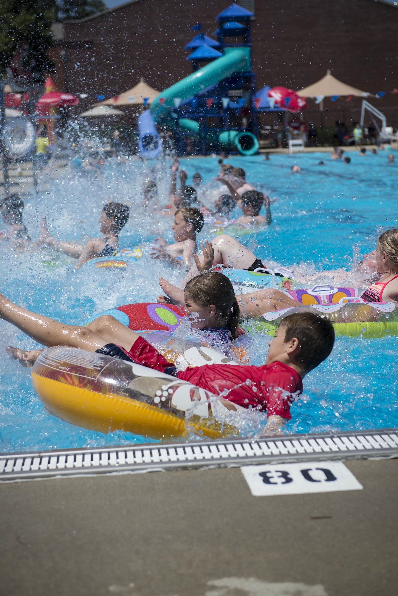 Team Scott members race each other to win a variety of prizes during the Scott Air Force Base pool grand opening June 17, 2016. The historic bathhouse facility underwent a facelift that included all-new flooring, stainless steel fixtures, energy efficient pumps, handicap accessible bathroom stalls and ramps, and slide upgrades. (U.S. Air Force photo/Senior Airman Jake Eckhardt)