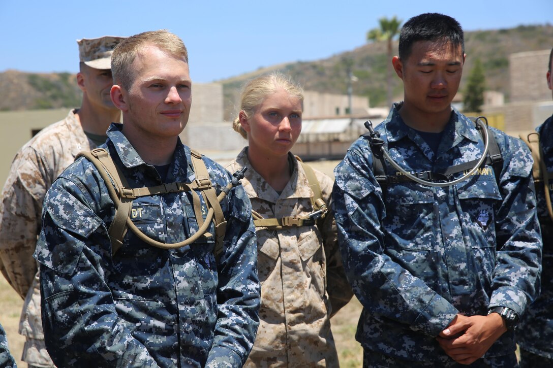 MARINE CORPS BASE CAMP PENDLETON, Calif. - Michelle Mathews, (center), and her fellow Midshipmen stand at ease while waiting for further instruction on the next phase of their training evolution of the Career Orientation and Training of Midshipmen program at Camp Pendleton June 16, 2016. Mathews runs track and plays volley ball for Villanova University in order to keep her physical fitness at a high level and relieve stress. The program allows college students, like Mathews, to familiarize themselves with some of the Marine Corps and Navy military operations and tactics without disrupting their education. (U.S. Marine Corps Photo by Cpl. Demetrius Morgan/RELEASED)