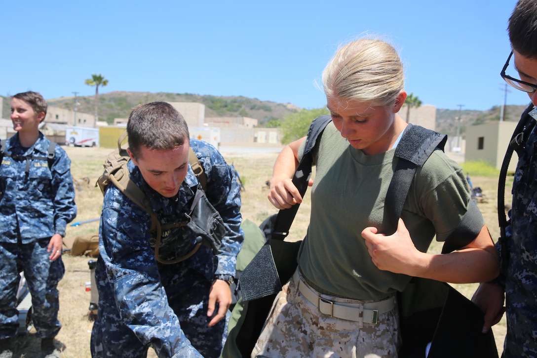 MARINE CORPS BASE CAMP PENDLETON, Calif. - Michelle Mathews tries on the Explosive Ordnance Disposal bomb suit as part of the Career Orientation and Training of Midshipmen program at Camp Pendleton June 16, 2016. Mathews balances education, sports and her aspirations to be in the Marine Corps through the program. Mathews and her fellow Midshipmen familiarized themselves with squad tactics, weapons handling and EOD equipment during the designated week of training.  (U.S. Marine Corps Photo by Cpl. Demetrius Morgan/RELEASED)