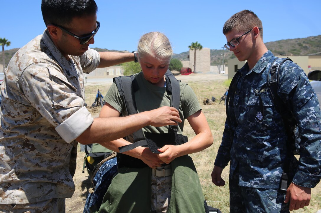 MARINE CORPS BASE CAMP PENDLETON, Calif. - Michelle Mathews tries on the Explosive Ordinance Disposal bomb suit as part of the Career Orientation and Training of Midshipmen program at Camp Pendleton June 16, 2016. Mathews balances education, sports and her aspirations to be in the Marine Corps through the program. Mathews’ and her fellow Midshipmen familiarized themselves with squad tactics, weapons handling and EOD equipment during the designated week of training.  (U.S. Marine Corps Photo by Cpl. Demetrius Morgan/RELEASED)