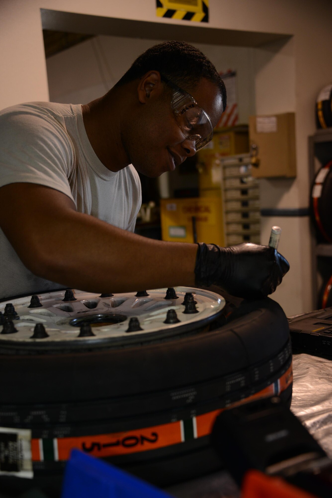 Senior Airman Brandon Culbreath, 56th Equipment Maintenance Squadron wheel and tire team member, labels a tire to indicate it has been torqued in accordance with technical data June 15, 2016, at Luke Air Force Base, Ariz. The wheel and tire section is responsible for disassembling, inspecting, repairing, assembling and servicing wheels for 43 F-35 Lightning II aircraft and 71 F-16 Fighting Falcon aircraft. (U.S. Air Force photo by Tech. Sgt. Timothy Boyer)