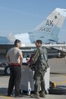 U.S. Air Force Staff Sgt. Dale LeCrone, a 354th Aircraft Maintenance Squadron dedicated crew chief, talks with Col. Brian Toth, the 354th Operations Group commander, before performing pre-flight checks June 16, 2016, during RED FLAG-Alaska (RF-A) 16-2, at Eielson Air Force Base, Alaska. As a prior 353rd Combat Training Squadron commander, Toth has held multiple roles in RF-A and uses that knowledge to make the joint training exercise as successful as possible. (U.S. Air Force photo by Staff Sgt. Ashley Nicole Taylor/Released)