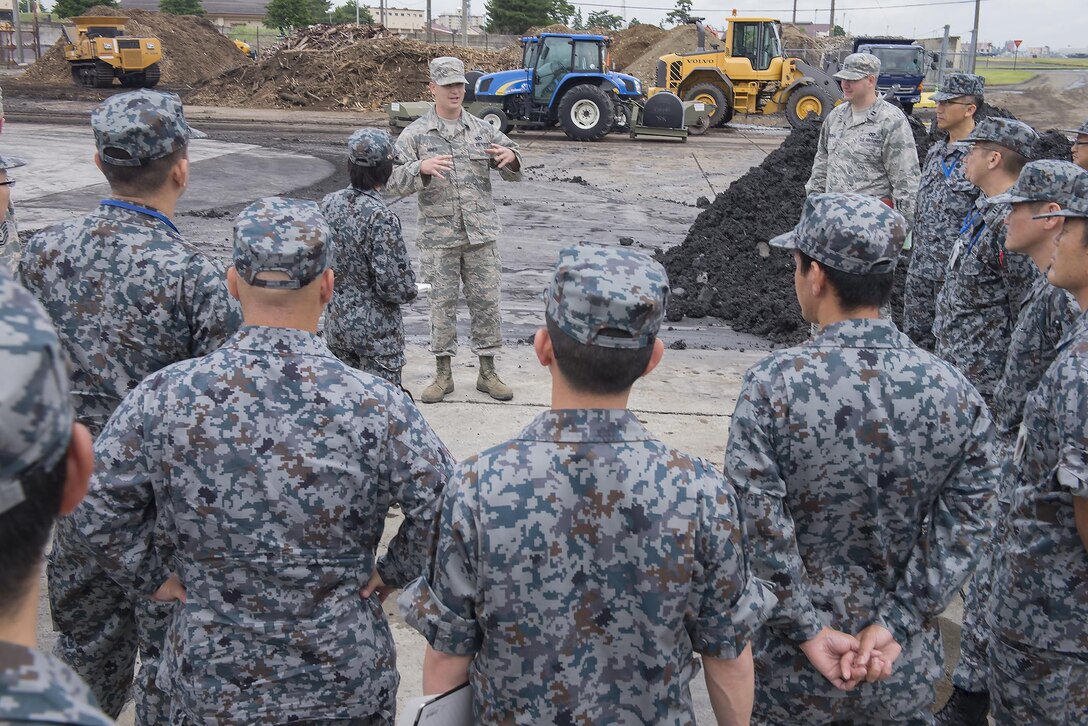 Tech. Sgt. Marcus Hines, 374th Civil Engineer Squadron NCO in charge of pavements and equipment, briefs Japan Air Self-Defense Force members on the airfield damage repair capabilities at Yokota Air Base, Japan, June 16, 2016. As part of the tour, the 374 CES demonstrated ADR and flightline emergency procedures. (U.S. Air Force photo by Senior Airman David C. Danford/Released)