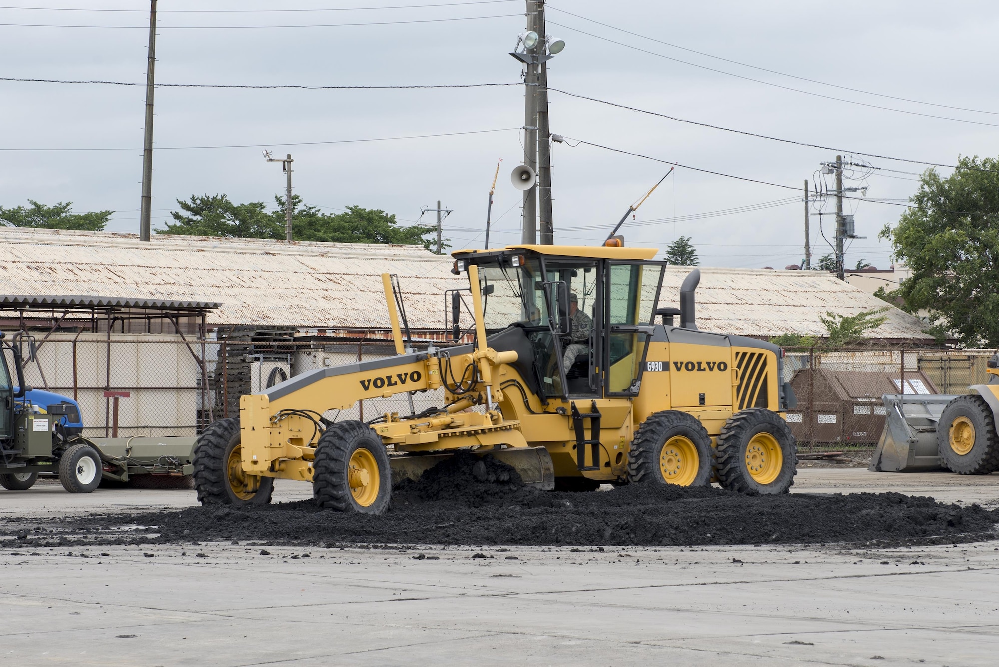 An Airman with the 374th Civil Engineer Squadron operates a Volvo G930 Motor Grader during an airfield damage repair demonstration at Yokota Air Base, Japan, June 16, 2016. The machine has an operating weight of approximately 21 tons and is used to level the flightline during repairs. (U.S. Air Force photo by Senior Airman David C. Danford/Released)