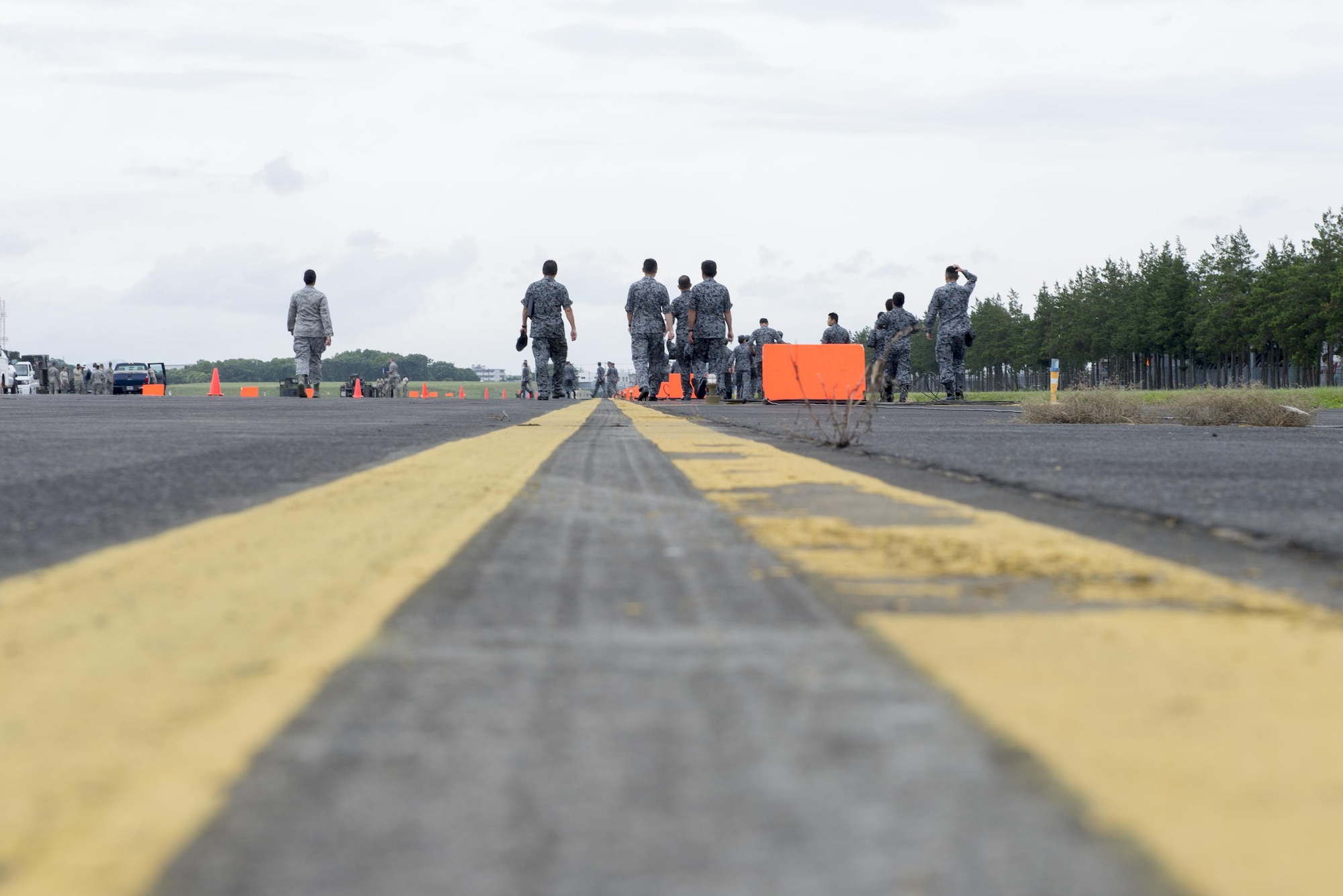 Japan Air Self-Defense Force members tour the flightline during a Prime Base Engineer Emergency Force demonstration at Yokota Air Base, Japan, June 16, 2016. As part of the tour, the 374th Civil Engineer Squadron displayed airfield damage repair procedures, the mobile aircraft arresting and the emergency airfield lighting systems. (U.S. Air Force photo by Senior Airman David C. Danford/Released)