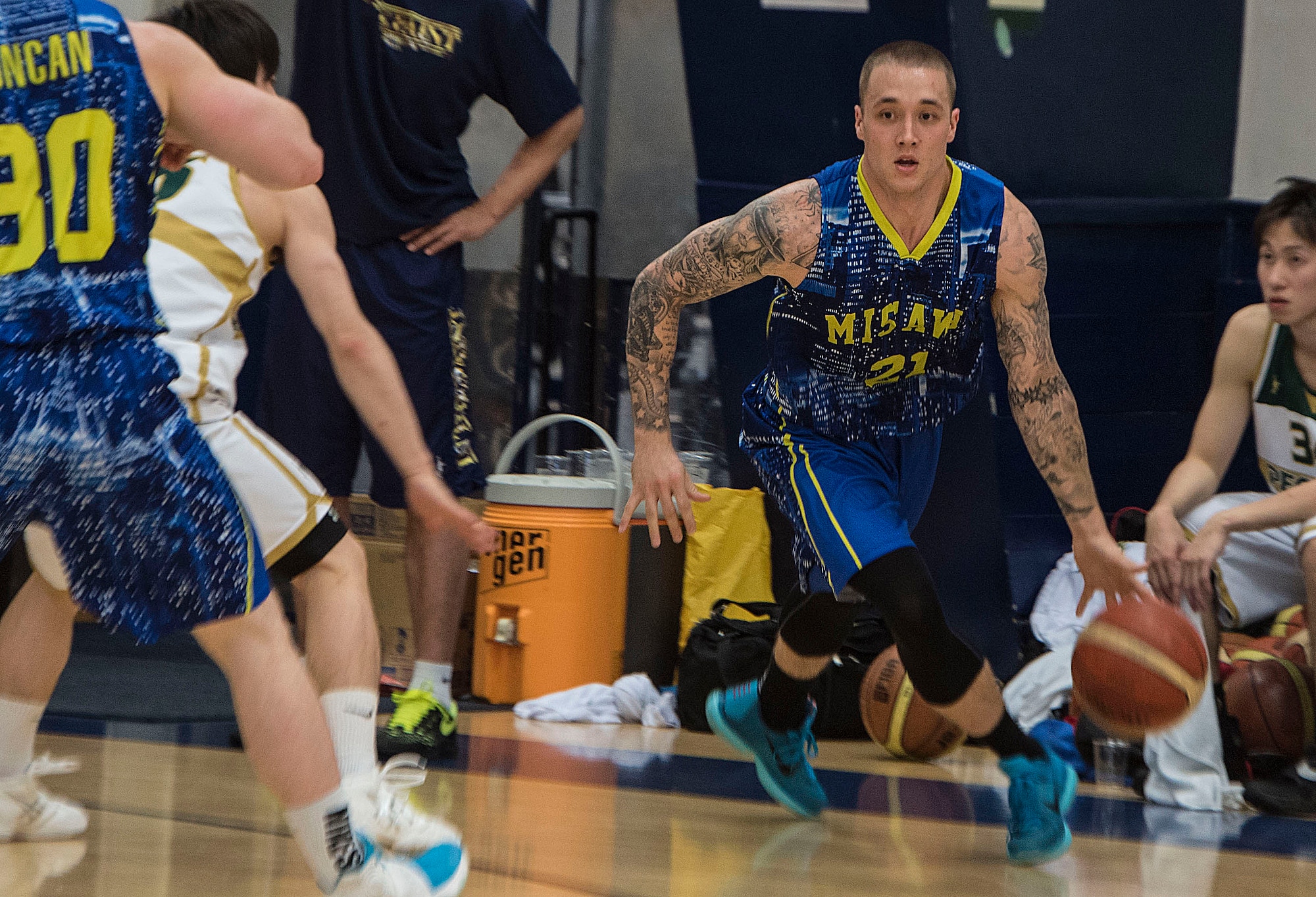 U.S. Air Force Staff Sgt. George Covington, the commander’s support staff NCO in charge with the 35th Aircraft Maintenance Squadron, dribbles a basketball at Misawa Air Base, Japan, June 17, 2016. The Japan Railway East Akita Peckers played the Misawa Jets as part of a basketball camp meant to foster bilateral relations and prepare players for the upcoming season. Covington is from Panama City, Florida. (U.S. Air Force photo by Airman 1st Class Jordyn Fetter)