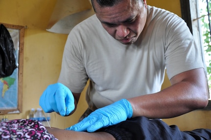 U.S Air Force Maj. Villanueva dry needles a patient in order to aid in relieving lower back-pain June 14, 2016, in Kampot Province, Cambodia. Throughout the course of the week doctors, dentists, and pharmacists from the U.S., Cambodia, Australia, Vietnam and Thai militaries and two non-governmental organizations, along with 65 volunteers from the provincial hospital and local villages, saw more than 3,400 patients at two different sites. Together they provided general health, dental, optometry, pediatrics, and physical therapy services. (U.S. Air Force photo by Capt. Susan Harrington/Released)