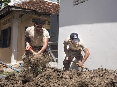U.S. Air Force Senior Airman Michael Bailey, 124th Civil Engineer Squadron, Idaho Air National Guard, and Airman 1st Class Joseph Walters, Joint Base Pearl Harbor-Hickam’s 647th Civil Engineer Squadron water and fuels maintainer shovel dirt for a drainage pipe at a health center during Pacific Angel 16-2 June 15, 2016, in Kampot Province, Cambodia. Pacific Angel helps cultivate common bonds and foster goodwill between the U.S., Cambodia, and other participating nations as they conduct multilateral humanitarian assistance and civil military operations together. The five nations participating in Pacific Angel 16-2 Cambodia include the U.S., Australia, Cambodia, Vietnam and Thailand. (U.S. Air Force photo by Senior Airman Omari Bernard/Released)