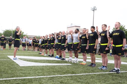 Fourteen Soldiers take the Army’s oath of enlistment with Maj. Gen. James F. Pasquarette, commanding general of USARJ, during a mass reenlistment ceremony held June 17 on the ZAHS football field for Camp Zama’s Army Birthday Week celebration. (U.S. Army photo by Lance D. Davis)