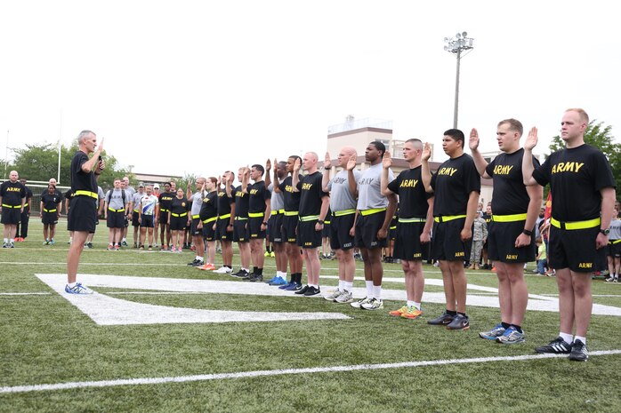 Fourteen Soldiers take the Army’s oath of enlistment with Maj. Gen. James F. Pasquarette, commanding general of USARJ, during a mass reenlistment ceremony held June 17 on the ZAHS football field for Camp Zama’s Army Birthday Week celebration. (U.S. Army photo by Lance D. Davis)