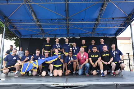 Aviation Battalion-Japan Soldiers pose on stage with their first place trophy for winning the overall Soldier unit competition for Army Birthday Week June 17 at the ZAHS football field. (U.S. Army photo by Lance D. Davis)