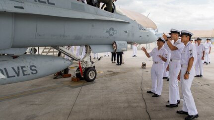 Japan Air Self-Defense Force aviation officer cadets from the Japan Maritime Self-Defense Force Ozuki Aviation Training Squadron observe and converse about an F/A-18C static display during a Japanese Officer Exchange Program tour at Marine Corps Air Station Iwakuni, Japan, June 17, 2016. Hosted by Marine Aircraft Group 12, the exchange program aims to better the understanding and working relationships between U.S. and Japanese pilots. The visit provides the cadets with greater knowledge and understanding of the present condition of the Marines in Japan. 