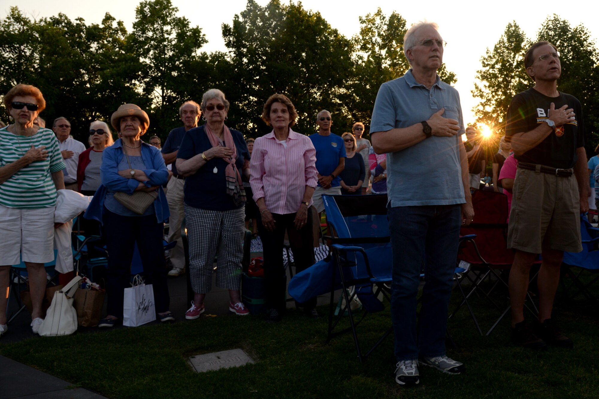Audience members stand while the U.S. Air Force Band performs the National Anthem at the Air Force Memorial in Arlington, Va., June 17, 2016. During the performance, the Macy’s Band Selection Committee announced the United States Air Force Band and Honor Guard will represent the Air Force and perform in New York City in the 2017 Macy’s Thanksgiving Day Parade. (U.S. Air Force photo/Tech. Sgt. Matt Davis)