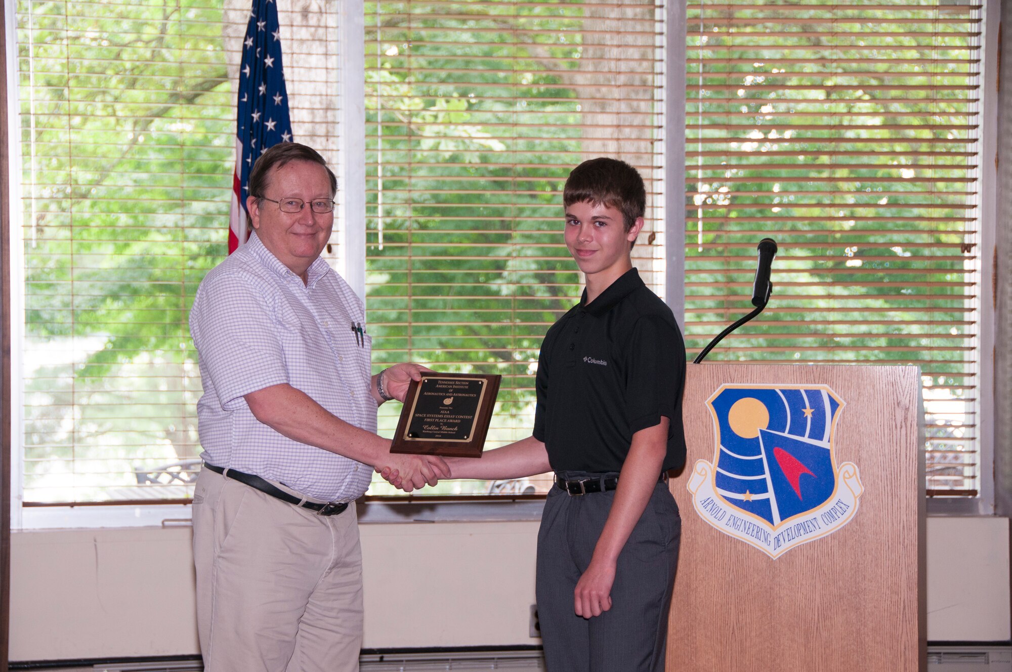 Collin Bunch (right), from Wartburg Central Middle School, receives a first place award from Jim Burns, with AEDC and chair of the AIAA Tennessee Section’s essay evaluation committee, for the AIAA Space Systems Essay Contest. (U.S. Air Force photos/Holly Peterson)

