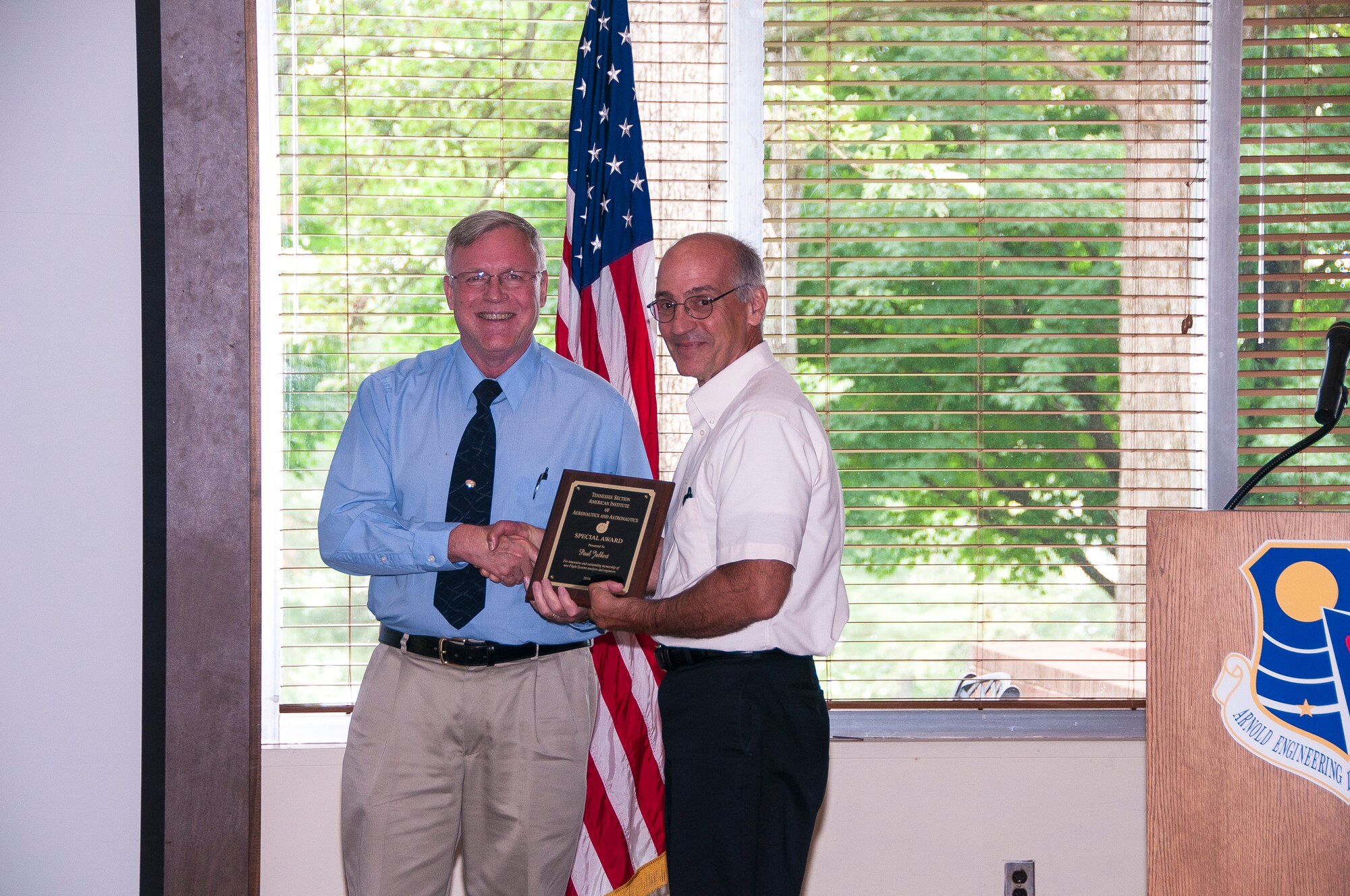 Paul Jalbert (right), a recent retiree from AEDC, receives an AIAA Special Award from nominator Rick Bishop, AEDC, for innovative and outstanding mentorship of new flight systems analysts and engineers. (U.S. Air Force photos/Holly Peterson)