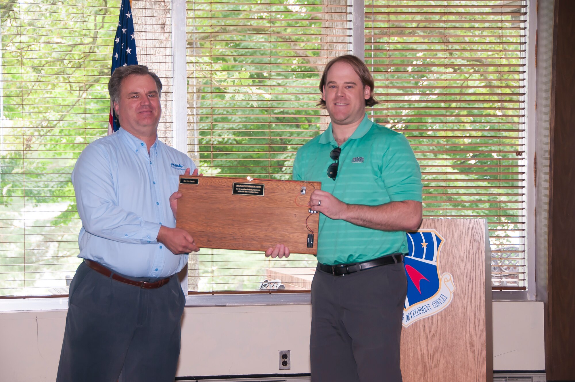 Eric Jacob (right), with Gloyer-Taylor Labs, receives the AIAA Originality Symposium Award from Dr. Joe Sheeley, with AEDC and AIAA Tennessee Section Chair. (U.S. Air Force photos/Holly Peterson)