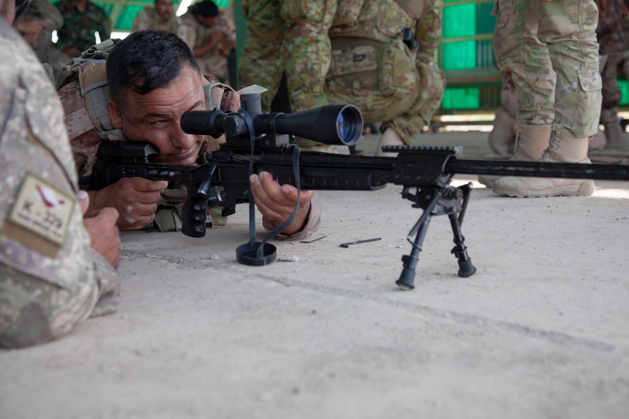 A New Zealand soldier, left, advises an Iraqi soldier on how to adjust his rifle’s sights at Camp Taji, Iraq, June 7, 2016. Task Group Taji conducted sniper rifle training during the junior leadership course to supplement Iraqi soldiers’ overall tactical capabilities. Training at building partner capacity sites is an integral part of Combined Joint Task Force – Operation Inherent Resolve’s multinational effort to train Iraqi security forces personnel to defeat the Islamic State of Iraq and the Levant. 