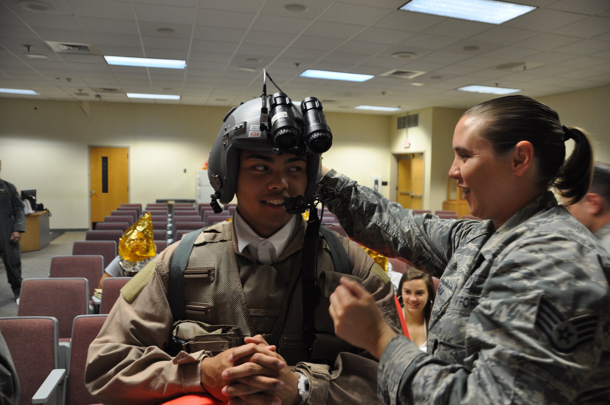 Pope Army Airfield, N.C.- Staff Sgt. Amber Palama, 440th Operations Support Squadron Aircrew Flight Equipment Team shows local high school students how to operate night vision goggles during the Leadership Fayetteville Tour, May 12. Palama is one of eight members of the 440th AFE Team that received the Air Force Reserve Command’s 2016 AFE Program of the Year Award.  (U.S. Air Force photo by Allison Janssen)