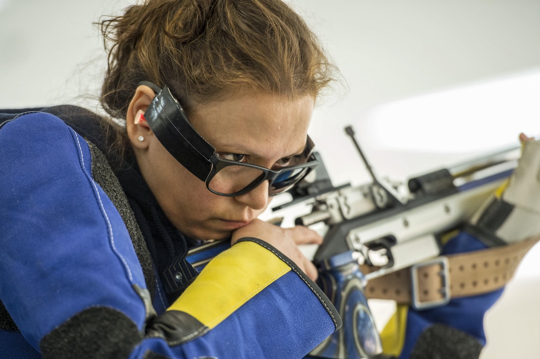 Navy Chief Petty Officer Maria Torres listens for her score at an air rifle competition during the 2016 Department of Defense Warrior Games at the U.S. Military Academy in West Point, N.Y., June 19, 2016. DoD photo by EJ Hersom