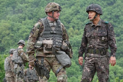 Lt. Col. Douglas Hayes, commander, 1st Battalion, 82nd Field Artillery Regiment, 1st Armored Brigade Combat Team, 1st Cavalry Division, and Republic of Korea Army Col. Seong Ik Sung, commander, 26th Mechanized Infantry Division Artillery, discuss the progress of a coordinated, joint artillery exercise May 10. The exercise, less than six miles from the Demilitarized Zone that separates North and South Korea, involved 30 self-propelled artillery from the U.S. and South Korea. (U.S. Army photo by Capt. John DePinto, 1st Battalion, 82nd Field Artillery Regiment, 1st ABCT)