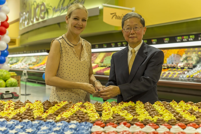 Kim Shipley, a station resident, left, and Joseph H. Jeu, director and CEO of the Defense Commissary Agency, cut the cake during the grand opening ceremony at Marine Corps Air Station Iwakuni, Japan, June 21, 2016. Designed to anticipate and meet the needs of shoppers, the new grocery store is approximately 50 percent larger, with 52,710 total square feet and is located between the Kintai Inn and Kawashimo housing area.  Sections of the improved facility include fresh produce, meat and frozen departments, an international delicatessen, a bakery and fresh, handmade sushi. (U.S. Marine Corps photo by Lance Cpl. Aaron Henson/Released)