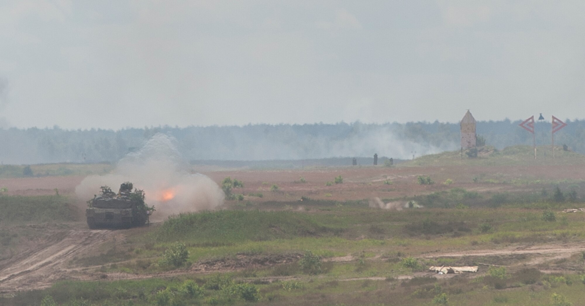 An M1 Abrams tank fires and moves forward with a group of tanks as part of a live-fire event during exercise Anakonda 2016 June 16, 2016, in Poland. The event was an opportunity for U.S. Airmen to train alongside allies and test aircraft, vehicles and other equipment in a live-fire exercise. The event served as a wrap up for Anakonda 2016, a Polish-led international exercise that aimed to train, exercise and integrate Poland and its allied forces by demonstrating their defense capabilities to deploy in mass numbers and sustain combat power. (U.S. Air Force photo/Airman 1st Class Lane T. Plummer)