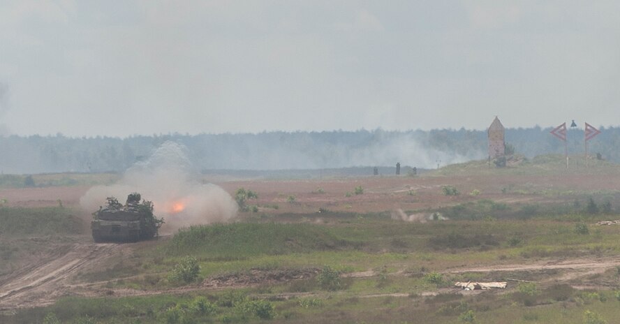 An M1 Abrams tank fires and moves forward with a group of tanks as part of a live-fire event during exercise Anakonda 2016 June 16, 2016, in Poland. The event was an opportunity for U.S. Airmen to train alongside allies and test aircraft, vehicles and other equipment in a live-fire exercise. The event served as a wrap up for Anakonda 2016, a Polish-led international exercise that aimed to train, exercise and integrate Poland and its allied forces by demonstrating their defense capabilities to deploy in mass numbers and sustain combat power. (U.S. Air Force photo/Airman 1st Class Lane T. Plummer)