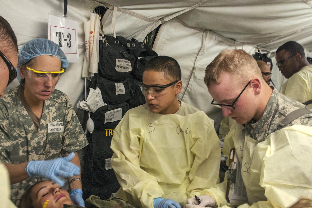 Army Reservist Spc. Adriana Rosas, center, provides medical treatment to a Polish trauma victim during a mass casualty exercise as part of Anakonda 2016 in Miloslawiec, Poland, June 11, 2016. Rosas is a medic assigned to the 228th Combat Support Hospital. Army photo by Sgt. 1st Class John Fries 