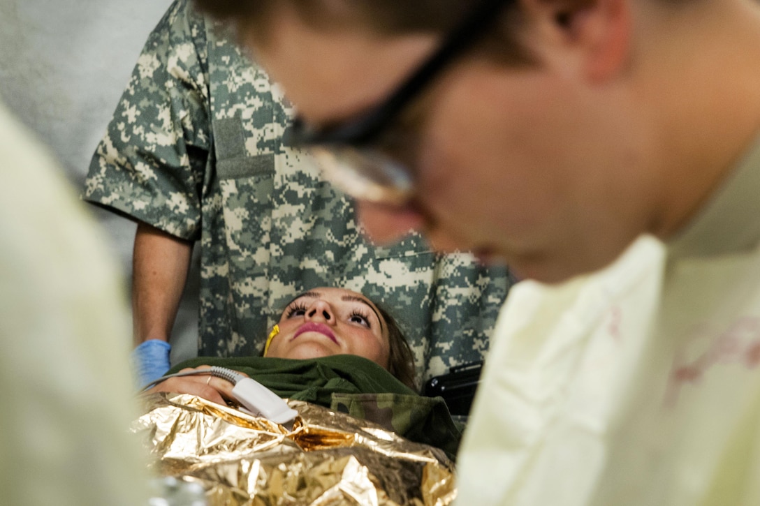 A Polish soldier, center, plays as a simulated patient receiving medical treatment from U.S. soldiers during a mass casualty exercise as part of Anakonda 2016 in Miloslawiec, Poland, June 11, 2016. Army photo by Sgt. 1st Class John Fries