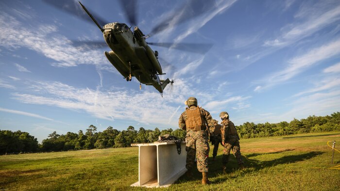 A CH-53E Super Stallion descends on an external load prepared by ground Marines during a training exercise at Landing Zone Albatross on Marine Corps Base Camp Lejeune, N.C., June 9, 2016. The purpose of external lifts is to transport large amounts of supplies and heavy gear into areas inaccessible by ground vehicles. 