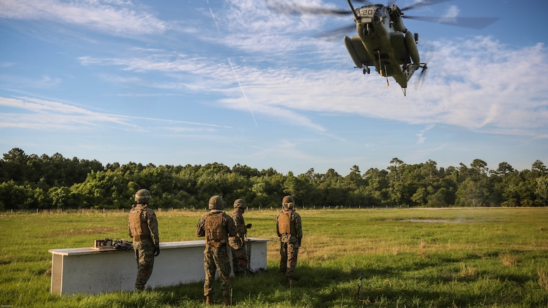 A CH-53E Super Stallion descends on an external load prepared by landing support specialist Marines during a training exercise at Landing Zone Albatross on Marine Corps Base Camp Lejeune, N.C., June 9, 2016. The purpose of external lifts is to transport large amounts of supplies and heavy gear into areas inaccessible by ground vehicles. 