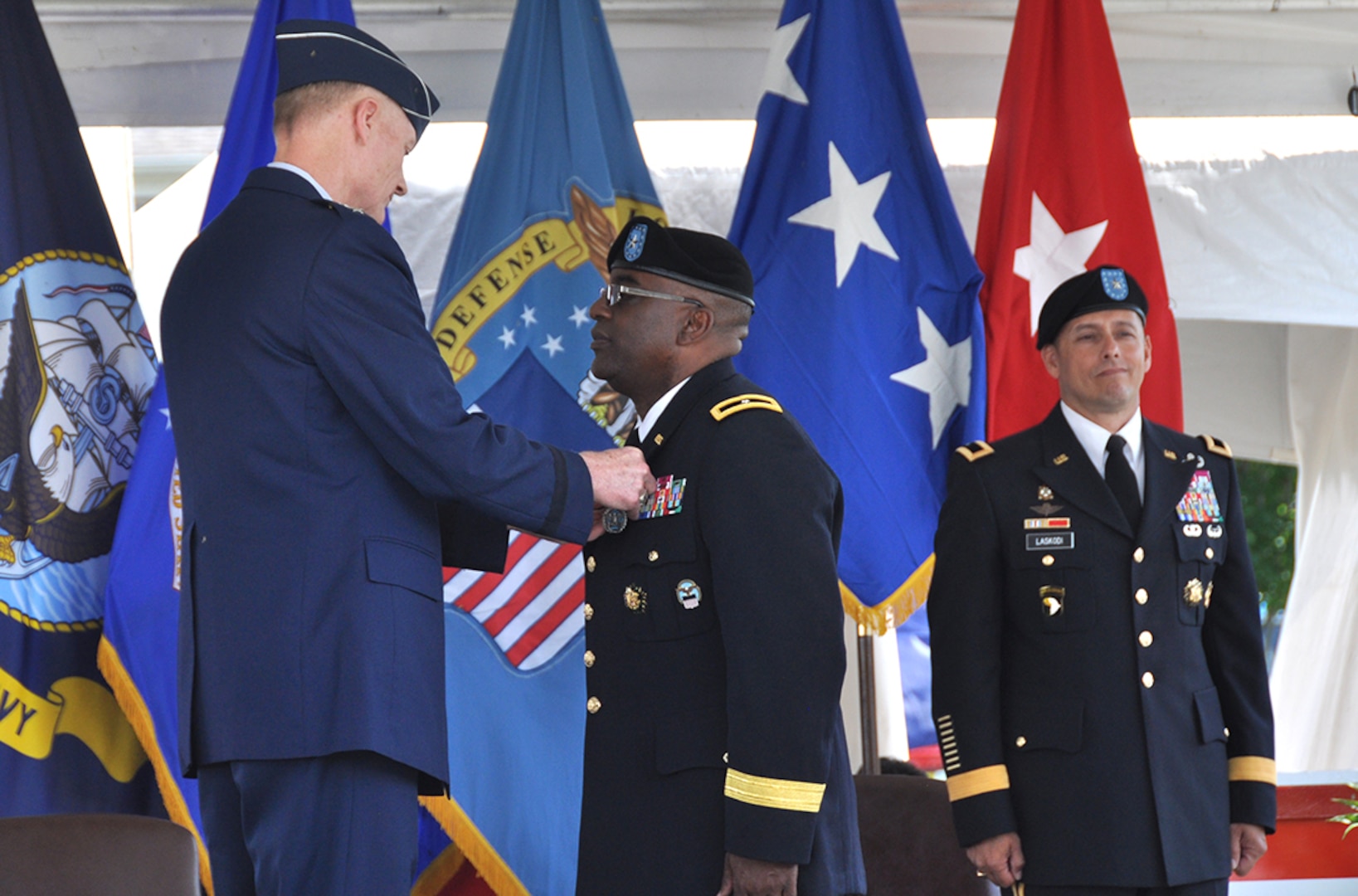 Air Force Lt. Gen. Andy Busch pins the Defense Superior Service Medal on Army Brig. Gen. Richard Dix as Brig. Gen. John Laskodi looks on at the DLA Distribution change of command ceremony in New Cumberland, Pennsylvania, June 17. Dix concluded 24 months as commander of DLA Distribution.