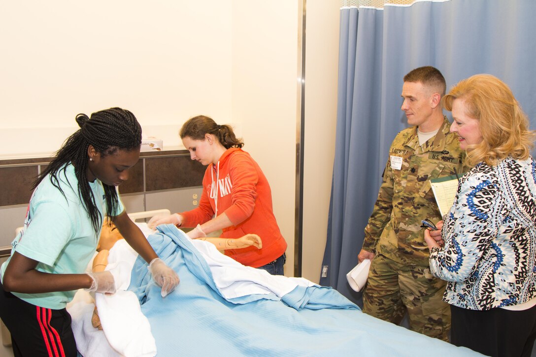 Lt. Col. Matthew Luzzatto, district commander, participated in the Charleston Metro Chamber of Commerce's Principal for a Day program where he shadowed the principal of Wando High School to learn about their STEM program. Here, he watches students practice their nursing skills as they prepare for jobs in the healthcare industry.