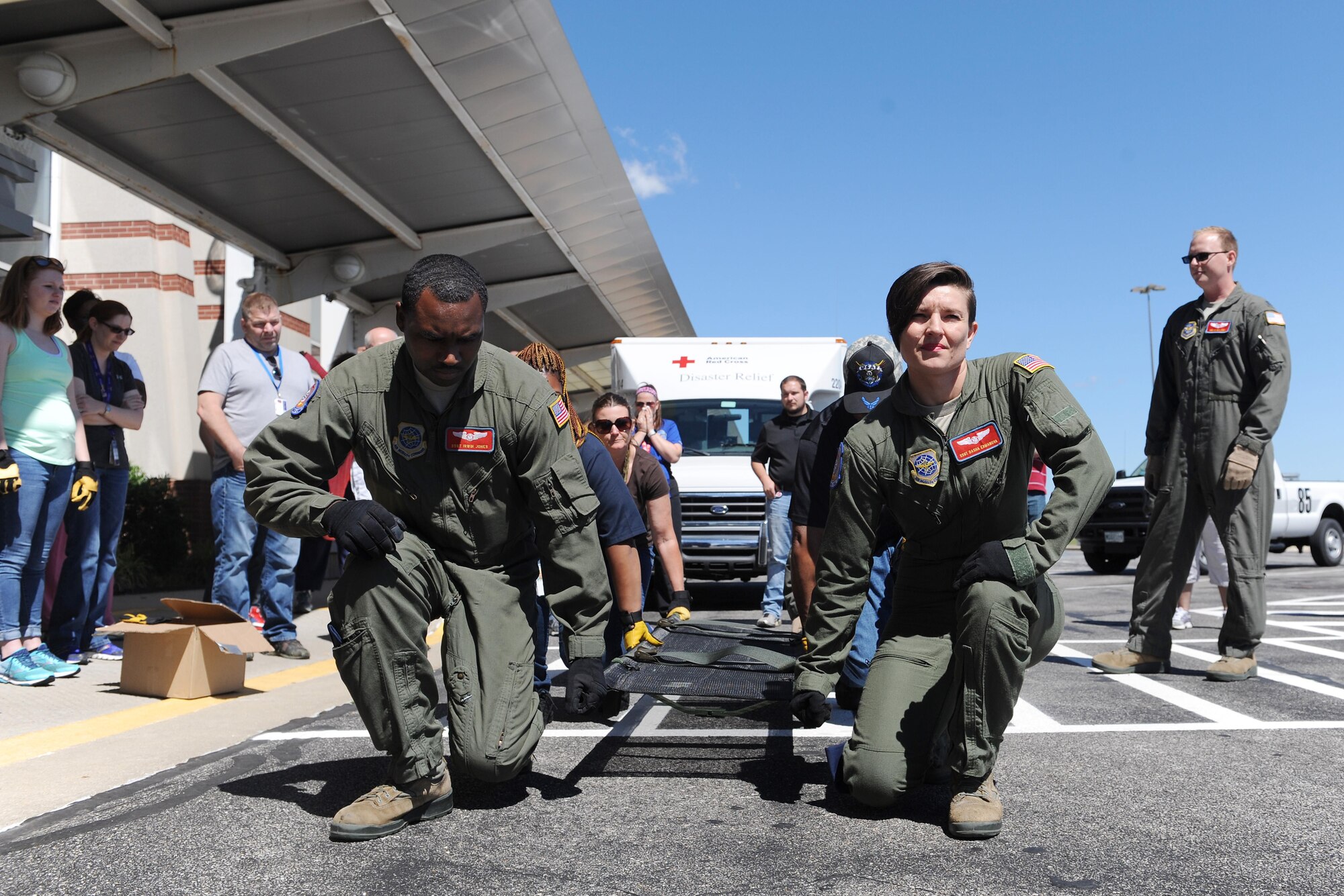 Staff Sgt. Irwin Jones, left, 375th Aeromedical Evacuation Squadron aeromedical evacuation technician, and Staff Sgt. Dasha Ermanova, right, 375th AES aeromedical evacuation technician, instruct U.S. Department of Veterans Affairs personnel on proper litter lift techniques during training June 7, 2016 at the MidAmerica St. Louis Airport in Mascoutah, Illinois. A litter is a stretcher used to move sick or injured patients. During natural disasters, civilian and military entities work together to get patients safely to medical facilities. (U.S. Air Force photo by Staff Sgt. Maria Bowman)