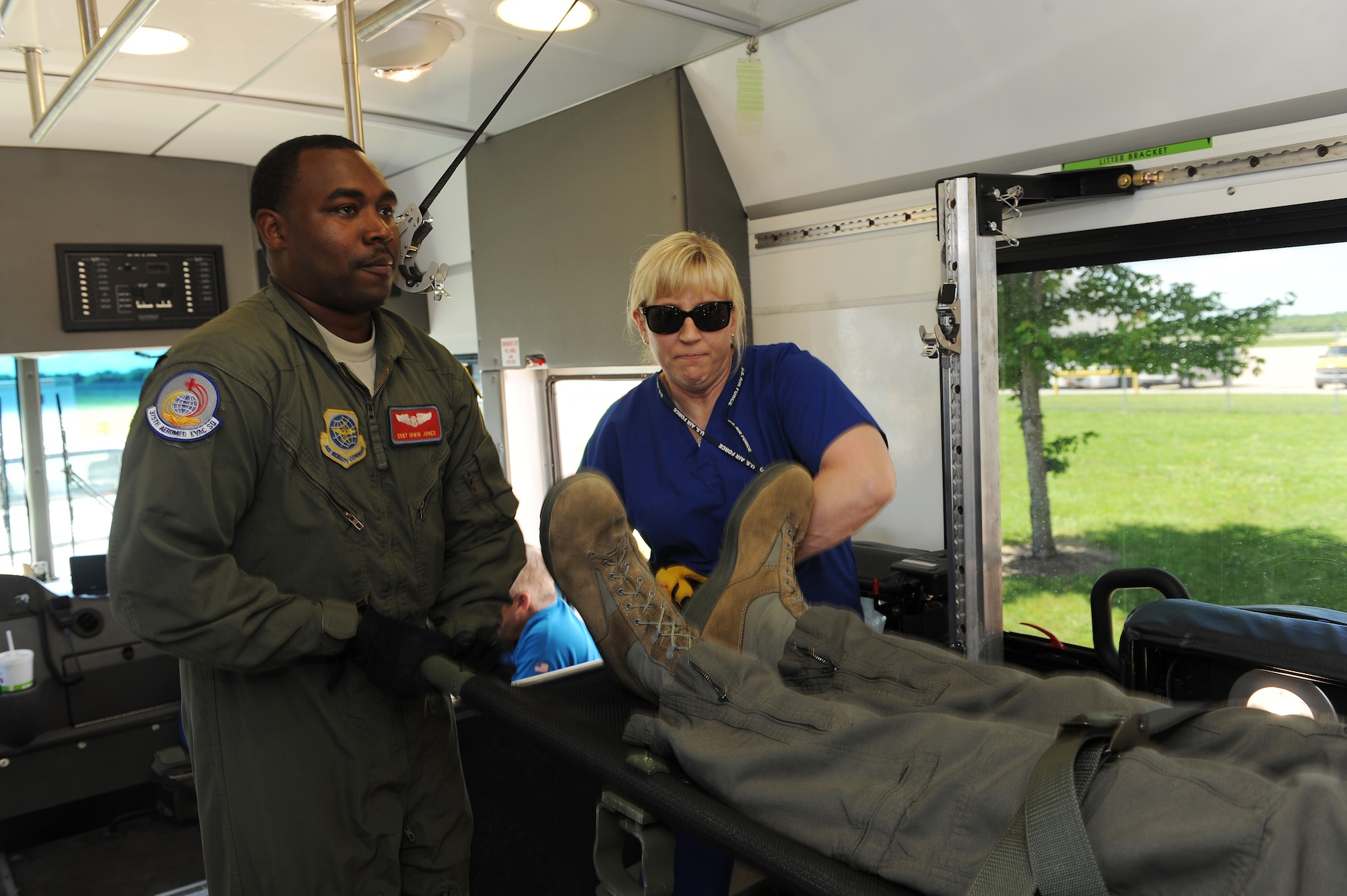 Staff Sgt. Irwin Jones, left, 375th Aeromedical Evacuation Squadron aeromedical evacuation technician, helps Shelby Mills, U.S. Department of Veterans Affairs nurse practitioner, lift a patient litter into place during training June 7, 2016 at the MidAmerica St. Louis Airport in Mascoutah, Illinois.   Since the DVA works with military entities during natural disasters and other emergency situations, the training familiarized DVA civilians on how the equipment the military uses. (U.S. Air Force photo by Staff Sgt. Maria Bowman)