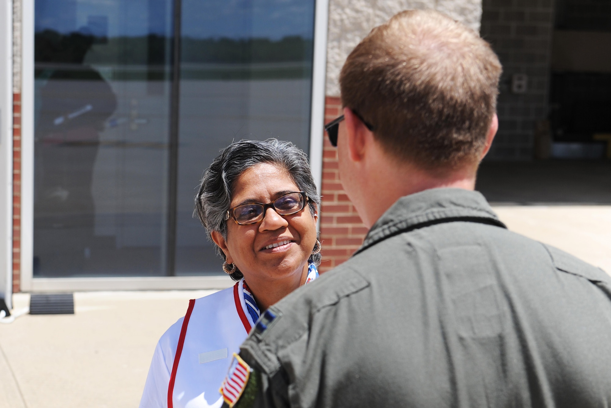 Parneeta Bhatia, U.S. Department of Veterans Affairs chief physician officer, talks with Capt. Kevin Holden, 375th Aeromedical Evacuation Squadron flight nurse, about military patient tranfer techniques during training June 7, 2016 at the MidAmerica St. Louis Airport in Mascoutah, Illinois. The training was conducted in order to familiarize the DMV on military equipment, so coordination efforts during natural and man-made disasters will be more effective. (U.S. Air Force photo by Staff Sgt. Maria Bowman)