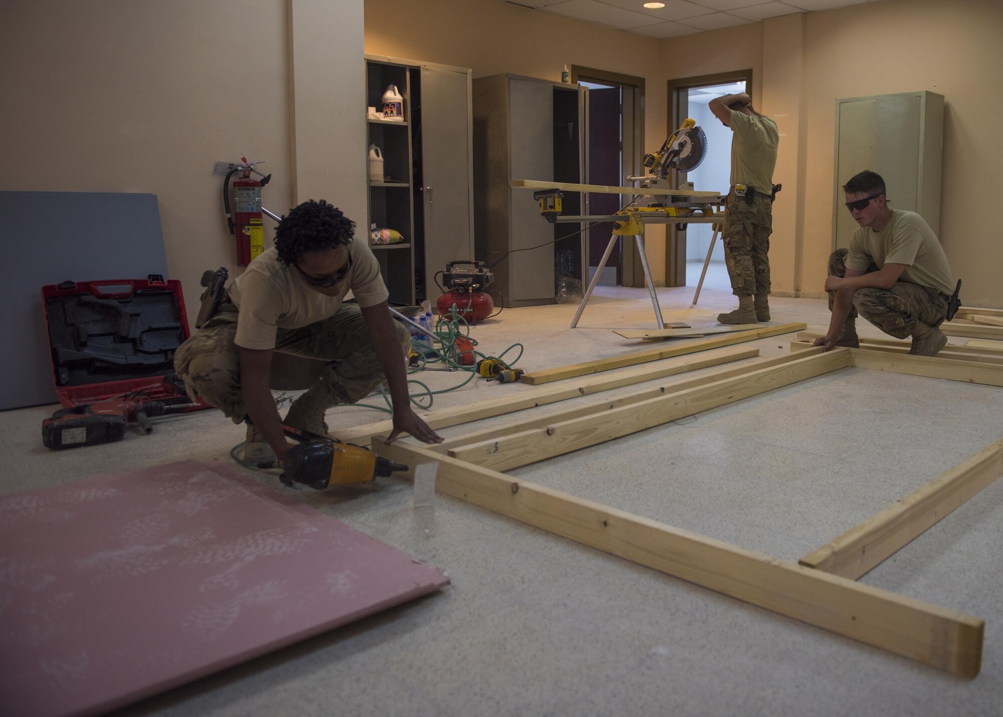 Senior Airman Jonathan Brooks (right), Senior Airman Eric Woolston (middle), and Airman 1st Class Taylor Davis (left), 455th Expeditionary Civil Engineer Squadron structural journeymen, nail a frame together as they construct a wall in the 455th Air Expeditionary Wing Headquarters building, June 20, 2016, Bagram Airfield, Afghanistan. Structural specialists have a varied skill set that is used along with specialized materials, and equipment to build numerous structures that range from locker rooms to improvised emergency disaster relief shelters. (U.S. Air Force photo by Senior Airman Justyn M. Freeman)
