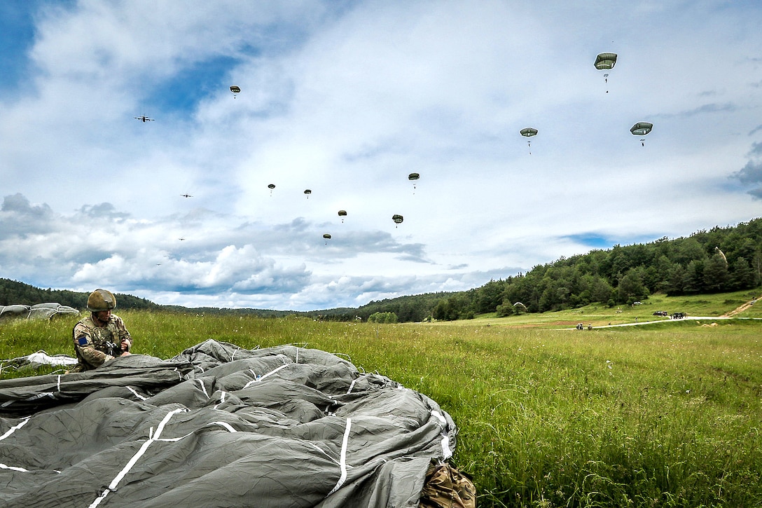 A British paratrooper recovers his chute after participating in an airborne operation during exercise Swift Response16 in Hohenfels, Germany, June 15, 2016. The British paratrooper is assigned to the 16th Air Assault Brigade's 3rd Para Battle Group. Army photo by Sgt. Juan F. Jimenez

