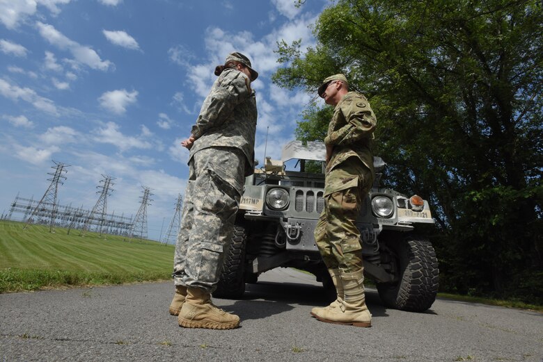 Maj. Gen. Jeffrey H. Holmes, deputy adjutant general for the Tennessee National Guard, receives an update from 1st Lt. Sabrina Rumpf, officer in charge of securing the facility and platoon leader with the 269th Military Police Company, 117th Military Police Battalion, 194th Engineer Brigade, during a security assistance exercise to protect the Old Hickory Dam Powerhouse and Switchyard in Hendersonville, Tenn., June 20, 2016.