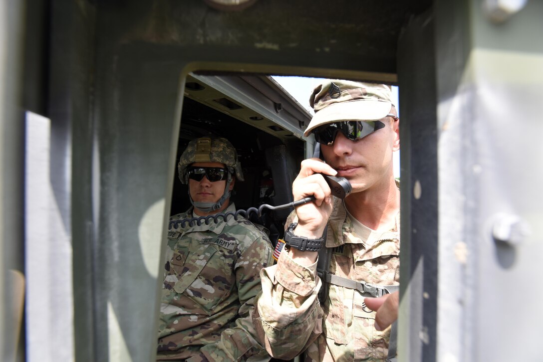 Soldiers with the Tennessee National Guard’s 269th Military Police Company, 117th Military Police Battalion, 194th Engineer Brigade, communicate during a security assistance exercise to protect the Old Hickory Dam Powerhouse and Switchyard in Hendersonville, Tenn., June 20, 2016.