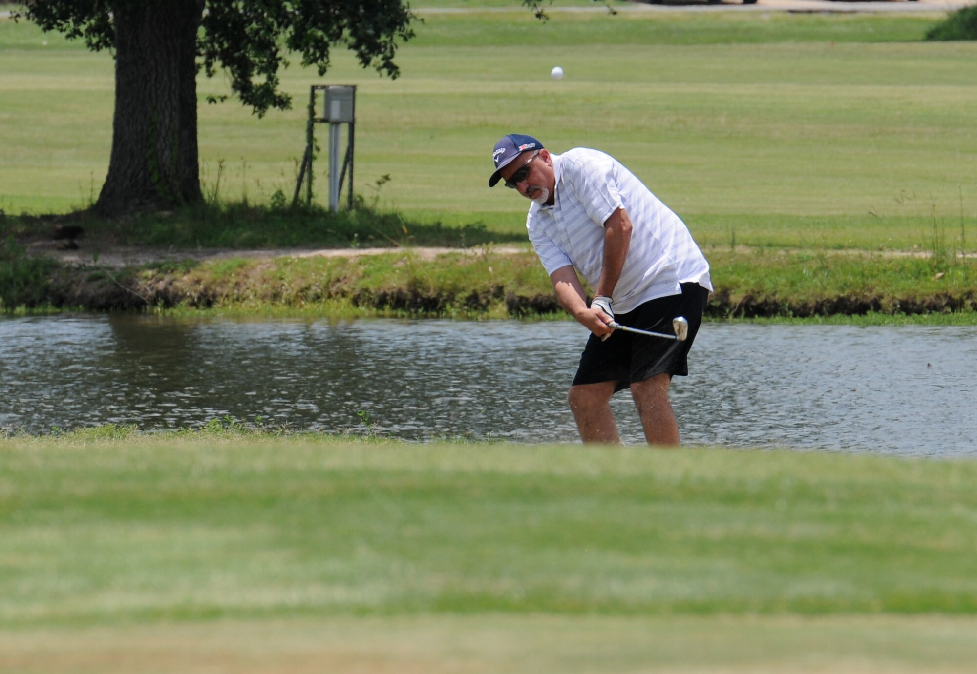 Barry Argento, 403rd Wing comptroller, takes a swing on hole #10 during the Don Wylie Memorial Golf Tournament at the Bay Breeze Golf Course June 17, 2016, Keesler Air Force Base, Miss. The annual tournament raised funds to help the Military & Veterans Affairs committee honor military members.  (U.S. Air Force photo by Kemberly Groue)