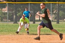 U.S. Air Force Maj. Michael Hickam, commander, 19th Comptroller Squadron, tries to out run the play, while participating in a One Pitch Softball game during Team Little Rock’s annual sports day at Little Rock Air Force Base, Ark., June 17, 2016. The comptroller squadron went on to win the game over the 19th Airlift Wing staff, by a score of 6-4. (U.S. Air Force photo by Master Sgt. Jeff Walston/Released)