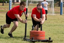 U.S. Air Force Senior Airman Kenneth Conley, power production journeyman, 19th Civil Engineer Squadron, and U.S. Air Force Staff Sgt. Leonard Stroud, water and fuels systems management superintendent, 19th CES, compete in the Strongman Challenge during Team Little Rock’s annual sports day at Little Rock Air Force Base, Ark., June 17, 2016. Servicemembers from the 19th Airlift Wing, 314th Airlift Wing, 913th Airlift Group and the Arkansas Air National Guard’s 189th Airlift Wing, participated in the day-long event as they competed for the commander’s cup and bragging rights. (U.S. Air Force photo by Master Sgt. Jeff Walston/Released) 
