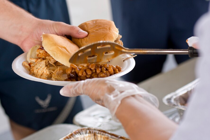 Volunteers serve lunch during Team Little Rock’s annual sports day at Little Rock Air Force Base, Ark., June 17, 2016. Servicemembers from the 19th Airlift Wing, 314th Airlift Wing, 913th Airlift Group and the Arkansas Air National Guard’s 189th Airlift Wing, participated in the day-long event as they competed for the commander’s cup and bragging rights. (U.S. Air Force photo by Master Sgt. Jeff Walston/Released)