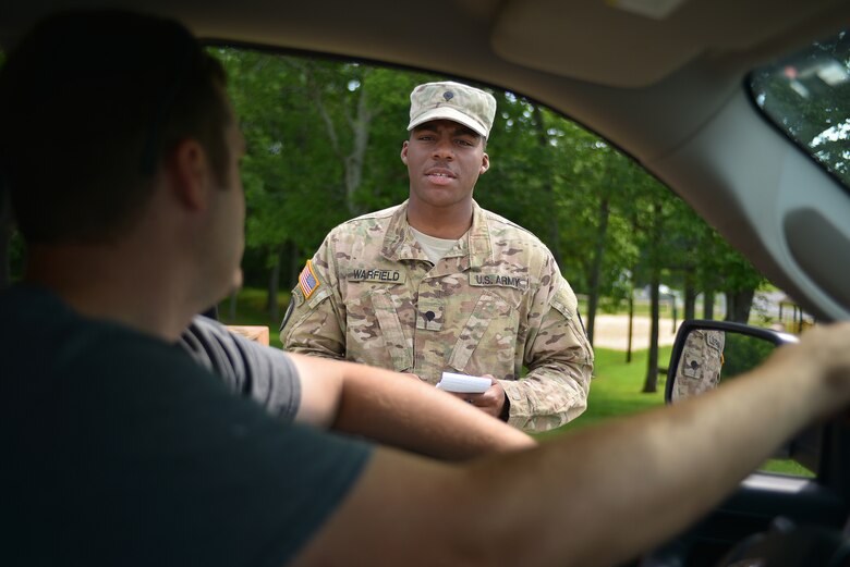 Spc. Darren Warfield from the Tennessee National Guard checks the identification of a U.S. Army Corps of Engineers employee at the Old Hickory Dam Powerhouse in Hendersonville, Tenn.  Soldiers set up road blocks and patrolled the area June, 20, 2016 to protect the facility during a security assistance exercise in cooperation with the U.S. Army Corps of Engineers Nashville District.