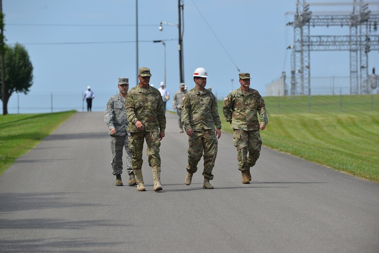 Corps of Engineers and Tennessee National Guard officials escort Maj. Gen. Jeffrey H. Holmes, deputy adjutant general for the Tennessee National Guard, to a security checkpoint at the Old Hickory Dam during a site visit to the facility during a security assistance exercise in Hendersonville, Tenn., June 20, 2016.  The general visited soldiers participating in the exercise and received an update from the platoon leader in charge of protecting the power plant and switchyard. 