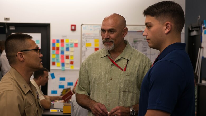 Col. William Seely III, Director of Intelligence Headquarters Marine Corps, (Left), Joseph Toscano, Branch Head for the Signals Intelligence Branch at Headquarters Marine Corps Intelligence Department, (Middle) and Cpl. Dennis Kirk, Libya Analyst for 2nd Marine Expeditionary Brigade (Right) discuss the five-day tech meeting in Stafford, Virginia, June 17, 2016. The meeting consisted of Marines of all ranks and military occupational specialties conversing about ways to improve intelligence community to better serve the Marine Corps. 