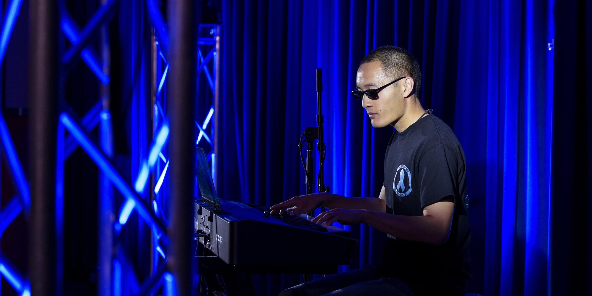 PETERSON AIR FORCE BASE, Colo. – Airman 1st Class Charlie Saechao, 21st Force Support Squadron plays the song “Hikari” by Utada Hikaru on the keyboard during the Peterson’s Got Talent competition at The Club on Peterson Air Force Base, Colo., June 14, 2016. The event was rescheduled for June due to weather. (U.S. Air Force Photo by Craig Denton)