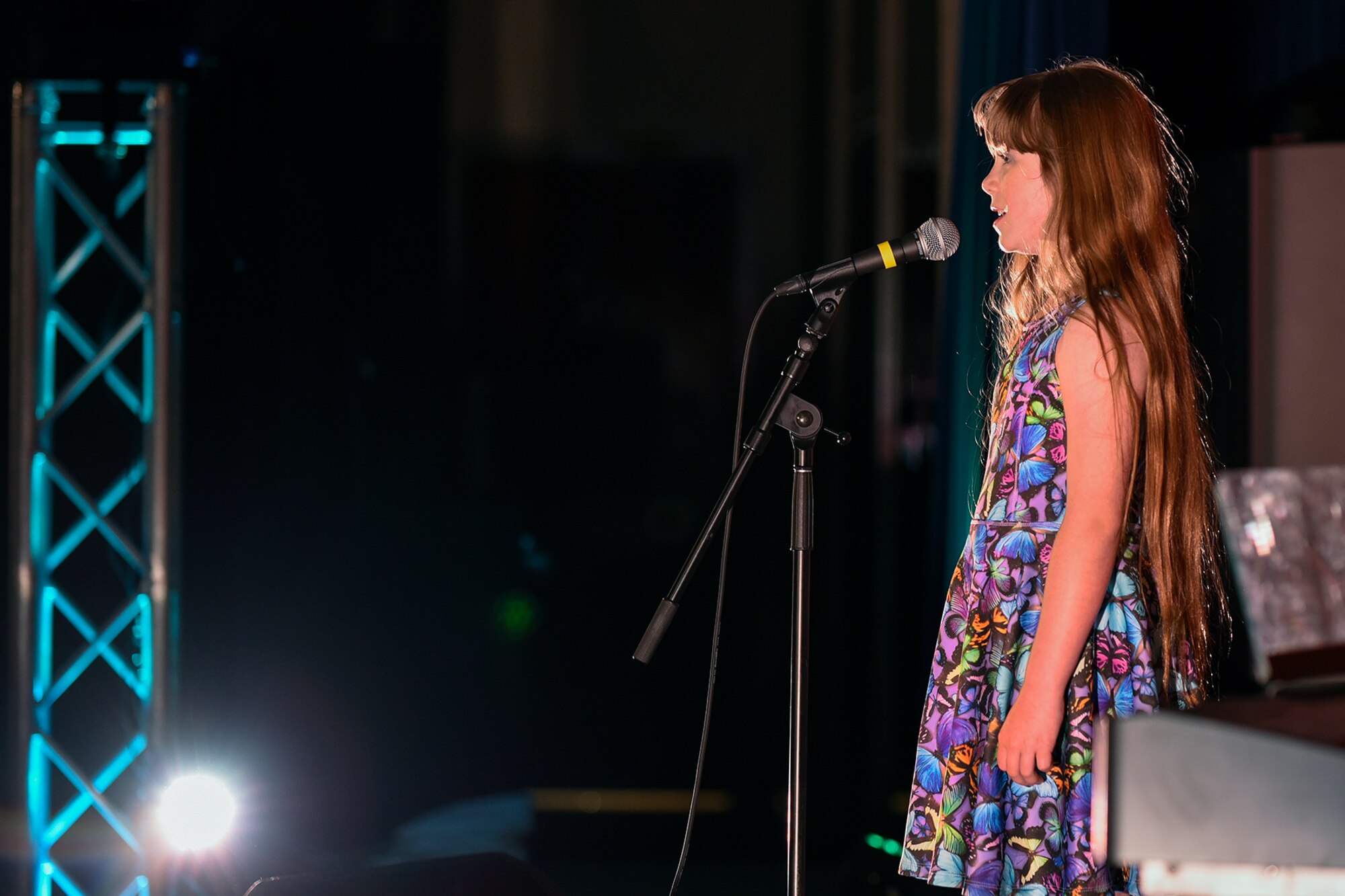 PETERSON AIR FORCE BASE, Colo. – Alexis Remy sings the “Fight Song” by Rachel Platten during the Peterson’s Got Talent competition at The Club on Peterson Air Force Base, Colo., June 14, 2016. Remy won first place for the preteen (ages 9-12) category and was presented a trophy and certificate by Col. Doug Schiess, 21st Space Wing commander and Chief Master Sgt. Idalia Peele, 21st Space Wing command chief master sergeant. (U.S. Air Force Photo by Craig Denton)